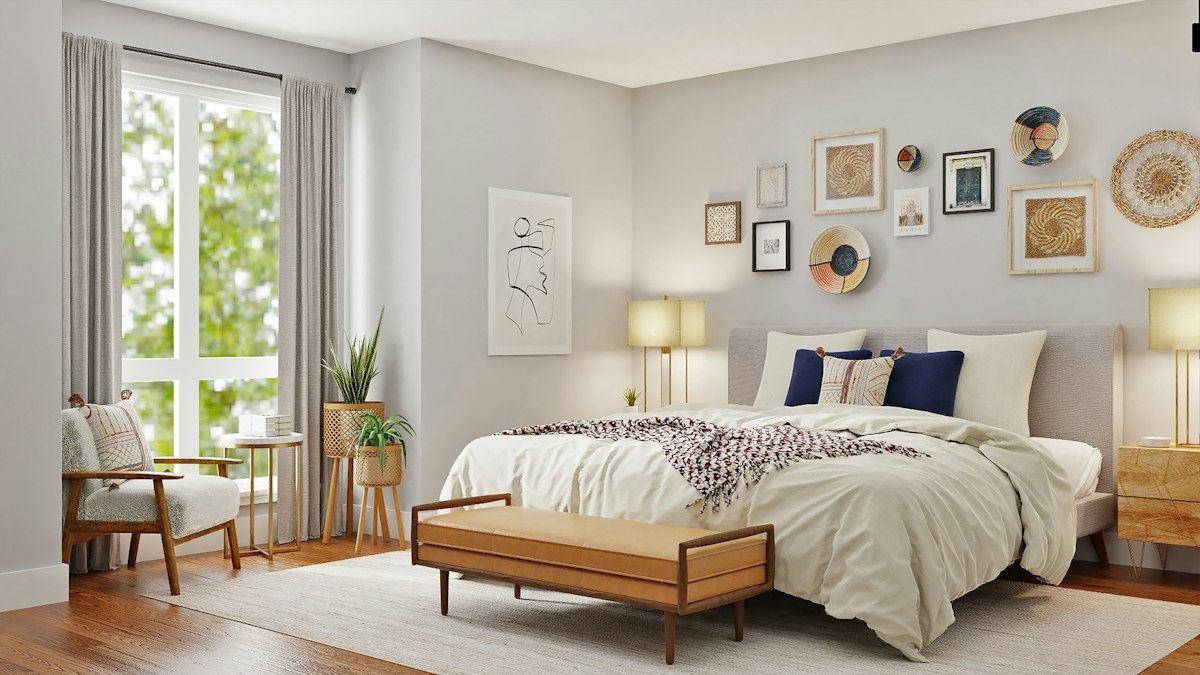 A calm bedroom with white linens and navy pillows
